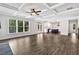 Open living room features wood floors and coffered ceilings connected to kitchen at 7474 Waterview Cv, Douglasville, GA 30135