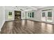 Open living room with a stone fireplace, wood floors, coffered ceilings and access to deck at 7474 Waterview Cv, Douglasville, GA 30135