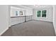 Bright, open loft space featuring plush carpeting, a modern chandelier, and natural light from large windows at 7474 Waterview Cv, Douglasville, GA 30135