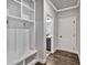 Mudroom with built-in bench and storage, leading to the interior and bathroom at 7474 Waterview Cv, Douglasville, GA 30135