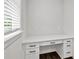 Bright office nook featuring a white desktop, drawers, and trim at 7474 Waterview Cv, Douglasville, GA 30135