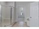 Bright bathroom features a glass shower, large soaking tub, and neutral tile flooring at 1209 Fenmore Hall Dr, Powder Springs, GA 30127