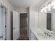 Clean bathroom with a long vanity, modern lighting, and access to additional rooms at 1209 Fenmore Hall Dr, Powder Springs, GA 30127