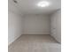 Spacious bedroom with neutral carpet, a modern light fixture, and a walk-in closet at 1209 Fenmore Hall Dr, Powder Springs, GA 30127
