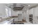 Modern kitchen with stainless steel appliances, white cabinetry, and a glass range hood at 1209 Fenmore Hall Dr, Powder Springs, GA 30127