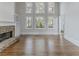 Spacious living room with a stone fireplace and large windows offering natural light at 1209 Fenmore Hall Dr, Powder Springs, GA 30127