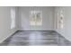 Versatile room with gray vinyl plank flooring, two windows, and French doors at 1209 Fenmore Hall Dr, Powder Springs, GA 30127
