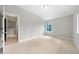 Neutral bedroom with large closet and window features neutral carpet and paint for relaxation at 1765 Stoney Creek Se Dr, Atlanta, GA 30316