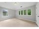 Spacious bedroom with multiple large windows and neutral carpet and paint creates a calming retreat at 1765 Stoney Creek Se Dr, Atlanta, GA 30316