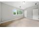 Bright bedroom featuring a large window, neutral carpet and paint provides a calm and airy space at 1765 Stoney Creek Se Dr, Atlanta, GA 30316