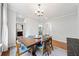 Cozy dining area featuring hardwood floors, a wooden table, and a chandelier for warm lighting at 1765 Stoney Creek Se Dr, Atlanta, GA 30316