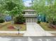Charming two-story home with a well-manicured lawn, mature trees, and a driveway leading to a two-car garage at 1765 Stoney Creek Se Dr, Atlanta, GA 30316