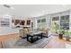 Open living room featuring hardwood floors, a fireplace, and connection to the kitchen at 1765 Stoney Creek Se Dr, Atlanta, GA 30316