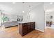 Open-concept living room with hardwood floors, white fireplace, and access to dining room at 1765 Stoney Creek Se Dr, Atlanta, GA 30316