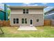 Rear exterior view of this two-story home with fenced backyard, patio, and lawn at 1765 Stoney Creek Se Dr, Atlanta, GA 30316