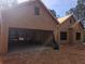 Exterior construction of a home with a large two-car garage and unfinished siding, set on a spacious lot at 190 Harville Rd, Covington, GA 30016
