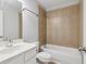 A well-lit bathroom with a shower-tub combo and a white sink and cabinet at 2620 Bent Creek Dr, Cumming, GA 30041