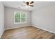Bedroom with wood-look floors, a ceiling fan, and a sunlit window with blinds at 2620 Bent Creek Dr, Cumming, GA 30041