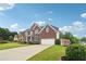 Attractive brick home on a lush lawn with blue shutters and a two-car garage at 2620 Bent Creek Dr, Cumming, GA 30041