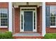 Elegant front entry with a stylish blue door and brick surround at 2620 Bent Creek Dr, Cumming, GA 30041