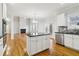Bright kitchen has white cabinets, an island and an opening to the large living space at 2620 Bent Creek Dr, Cumming, GA 30041