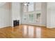 Bright living room with a fireplace, hardwood flooring, and tall windows at 2620 Bent Creek Dr, Cumming, GA 30041