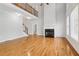 Open living space with hardwood floors, fireplace, and a staircase leading to the second floor at 2620 Bent Creek Dr, Cumming, GA 30041