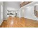 Open-concept living room featuring gleaming hardwood floors and staircase to second level at 2620 Bent Creek Dr, Cumming, GA 30041