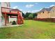 Backyard with lawn featuring a home's raised deck and stairs, surrounded by well-maintained fencing for privacy at 2620 Bent Creek Dr, Cumming, GA 30041