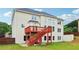 Backyard view of a two-story home featuring a wooden deck with stair access and traditional siding at 2620 Bent Creek Dr, Cumming, GA 30041