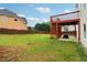 Large backyard with lawn, a wood fence, and deck, ideal for outdoor activities at 2620 Bent Creek Dr, Cumming, GA 30041