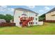 Nice backyard showcasing a two-story home with a deck, stair access, and surrounded by a wooden privacy fence at 2620 Bent Creek Dr, Cumming, GA 30041