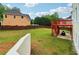 Spacious grassy backyard with wooden fence and deck, offering outdoor living and recreational space at 2620 Bent Creek Dr, Cumming, GA 30041