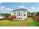 Expansive backyard featuring a two-story home with a deck and stair access, perfect for outdoor entertaining at 2620 Bent Creek Dr, Cumming, GA 30041