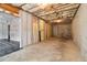 Basement area featuring a concrete floor, exposed ceiling, and unfinished brick accent wall at 2620 Bent Creek Dr, Cumming, GA 30041