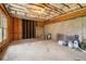 Unfinished basement with exposed ceiling, concrete walls, and natural light from window at 2620 Bent Creek Dr, Cumming, GA 30041