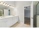 Bright bathroom featuring dual sinks and a soaking tub/shower at 2620 Bent Creek Dr, Cumming, GA 30041