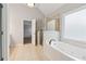 Bathroom features tiled shower, soaking tub with jets, and bright light at 2620 Bent Creek Dr, Cumming, GA 30041