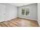 Bedroom with wood-look flooring, neutral paint, and natural light at 2620 Bent Creek Dr, Cumming, GA 30041