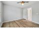 A neutral-walled bedroom with laminate flooring is bright with light entering the window at 2620 Bent Creek Dr, Cumming, GA 30041