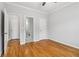 Well-lit bedroom with hardwood floors, offering access to a full bathroom and closet at 2620 Bent Creek Dr, Cumming, GA 30041