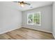 A bedroom with neutral walls, wood floors, and natural light at 2620 Bent Creek Dr, Cumming, GA 30041