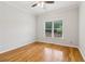 Bright bedroom features a ceiling fan, hardwood floors, and a window offering natural light at 2620 Bent Creek Dr, Cumming, GA 30041