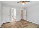 This bedroom features neutral walls, modern ceiling fan, and warm, wood-look flooring at 2620 Bent Creek Dr, Cumming, GA 30041