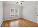 Cozy bedroom with hardwood floors, neutral paint, and a window overlooking the neighborhood at 2620 Bent Creek Dr, Cumming, GA 30041