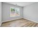 A bedroom with neutral walls, wood floors, and natural light at 2620 Bent Creek Dr, Cumming, GA 30041