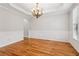 An elegant dining room featuring wainscoting, modern lighting, and hardwood floors at 2620 Bent Creek Dr, Cumming, GA 30041