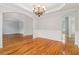 The hardwood floors in this dining space highlight the elegant arches and moldings at 2620 Bent Creek Dr, Cumming, GA 30041