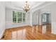 A spacious dining room featuring hardwood floors, modern lighting, and a large window at 2620 Bent Creek Dr, Cumming, GA 30041
