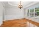 An elegant dining room featuring wainscoting, modern lighting, and hardwood floors at 2620 Bent Creek Dr, Cumming, GA 30041